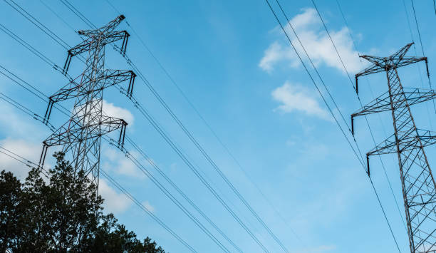 istock A high-voltage electricity pylon against blue sky with clouds at sunny day. High-voltage power transmission tower. Power engineering. 1160225146