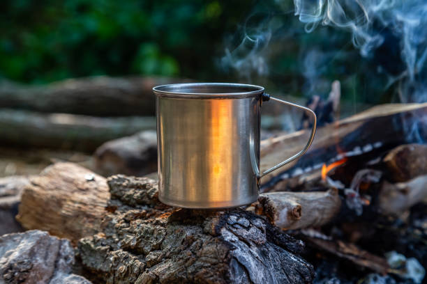 istock steel cup on an open fire in nature. 1160227432