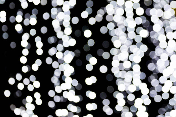 istock Bokeh white lights on black background. Abstract defocused many round light 1160228381