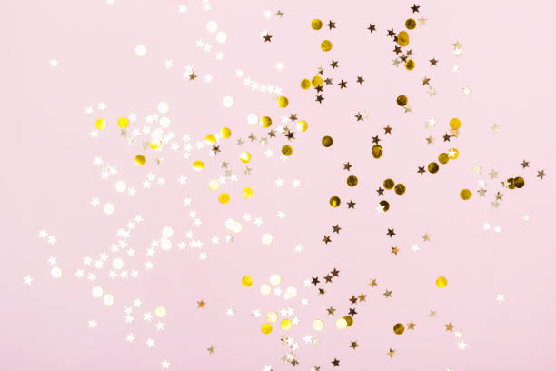istock Gold Stars Glitter Confetti on pink background. Festive backdrop 1160229789