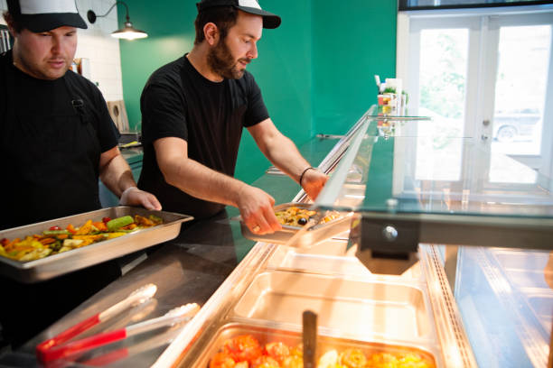 Employees working in zero waste oriented grocery and take out food store.