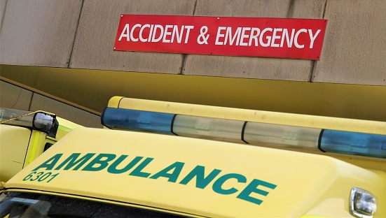 The top of an NHS ambulance cab showing the ambulance sign below a sign saying accident and emergency