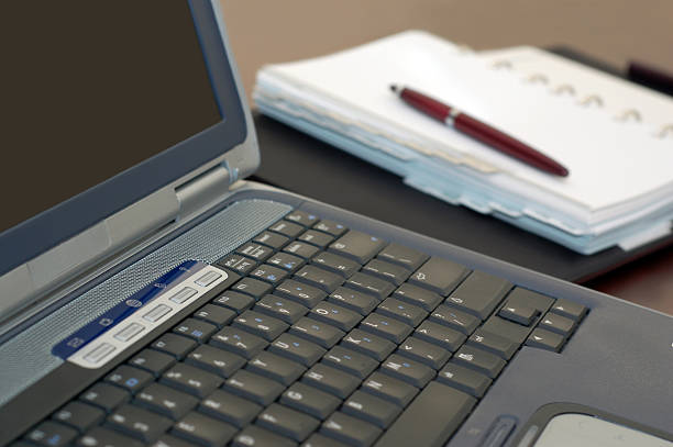 istock Laptop Notebook Computer, Personal Organizer, and Pen on a Desk 116023052