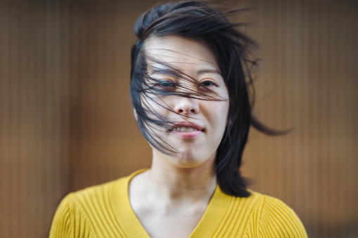 A portrait of a young woman on a windy day.