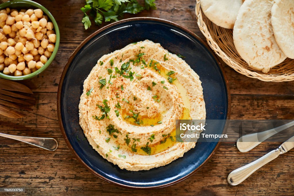 Vegan food, plate with hummus ready to serve. Lifestyle vegan diner Hummus - Food Stock Photo