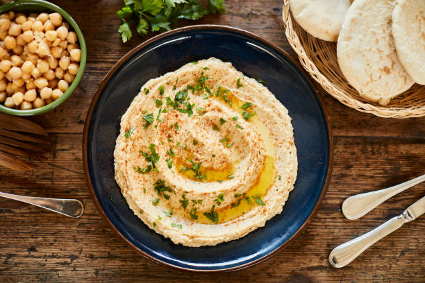 Vegan food, plate with hummus ready to serve. Lifestyle vegan diner lebanese culture stock pictures, royalty-free photos & images