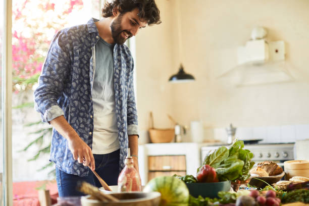 istock Friends cooking salad a and adding salad dressing. 1160233793