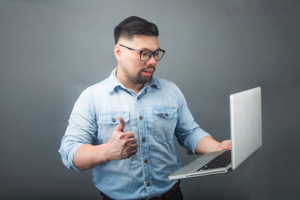 istock a mature man holding a computer and coffee 1160234177