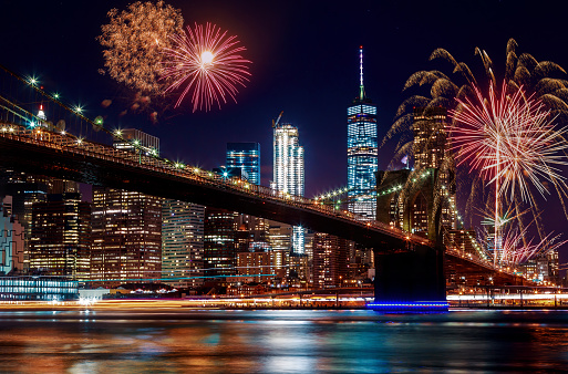 Colorful and vibrant fireworks at dusk Manhattan skyline from the Brooklyn Bridge in Independence day New York City
