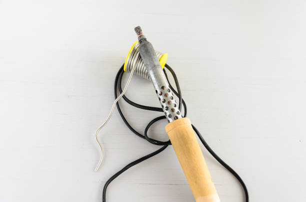 istock solder wire and soldering iron with wooden handle on gray background 1160236480