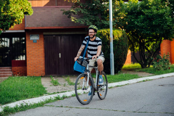 istock Man cycling on the street 1160239881