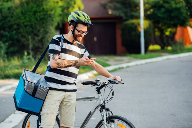 istock Man with bike using smartphone 1160239891