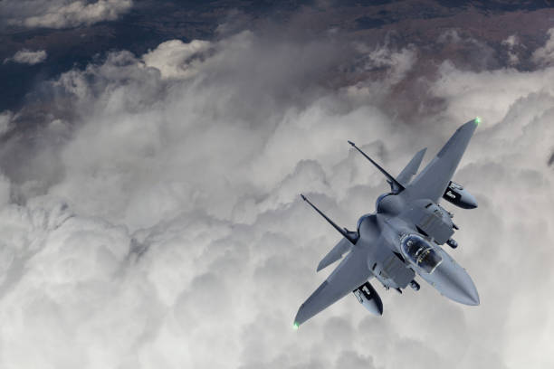 istock F-15 Fighter Jet flying over clouds 1160240235