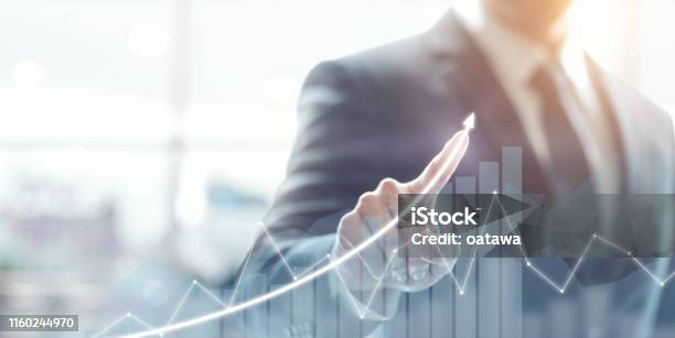 Development And Growth Concept Businessman Plan Growth And Increase Of Positive Indicators In His Business Stock Photo - Download Image Now