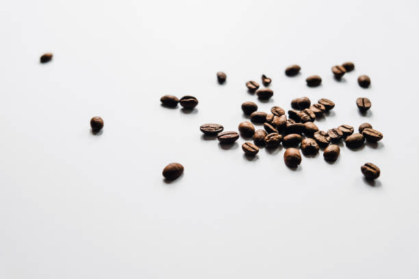 istock Brown coffee beans scattered on the table. 1160248176