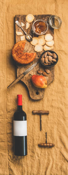 istock Wine bottle, vintage corkscrews and appetizers board, vertical composition 1160249569