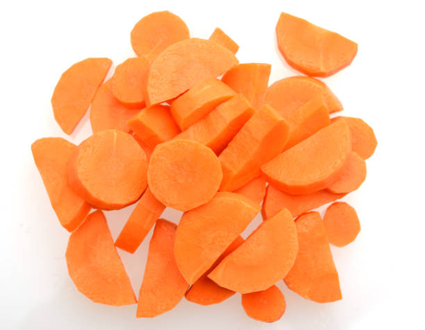 istock Ripe chopped carrots on white background 1160249926