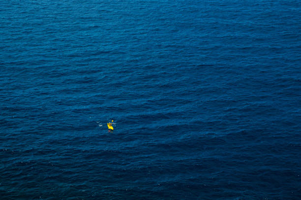 istock Yellow kayak in blue sea 1160250928