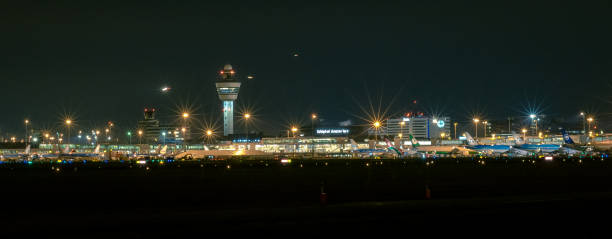 Panoramic view of Schiphol Amsterdam International Airport by Night Control Tower, buildings and aircraft of the largest airport of The Netherlands. aircraft point of view stock pictures, royalty-free photos & images