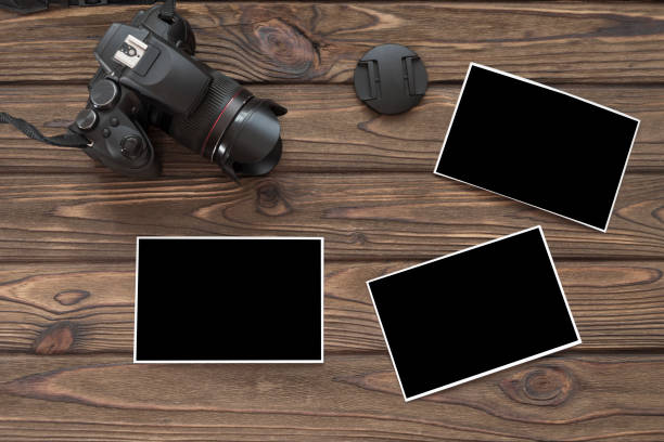 camera, photo paper on a wooden background. photographer, creativity, photo.