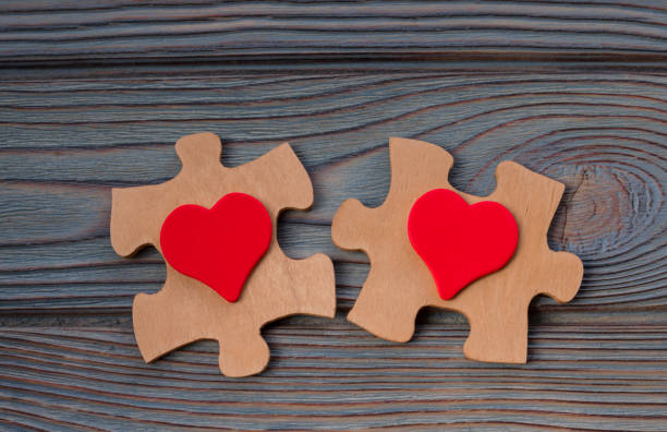 istock two pieces of a puzzle with a red heart, unite into a single whole. 1160252738