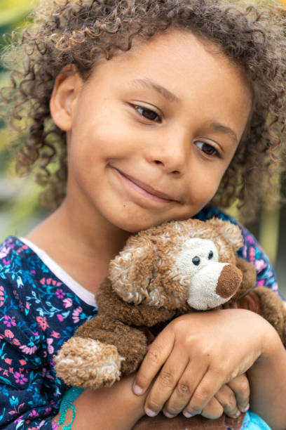 istock Smiling little girl posing with her teddy bear 1160253676