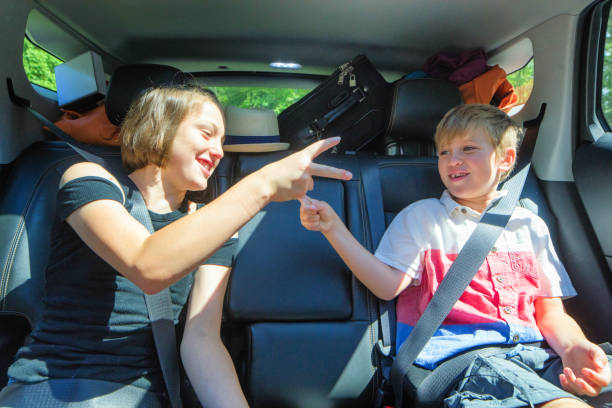 istock Young siblings playing in packed car on a road trip 1160255332