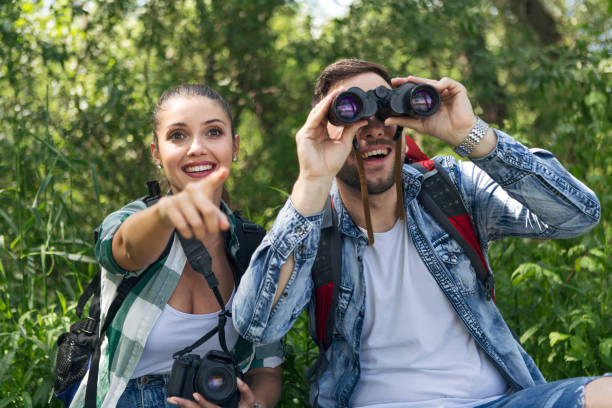 istock Young couple are resting in nature looking through binoculars 1160256496