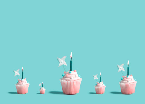 istock Big and small cupcakes with lit candles 1160259520
