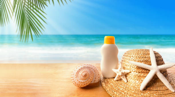 istock Sunblock with straw hat on a tropical beach 1160259583