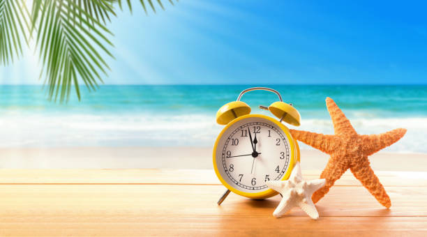 Clock showing nearly 12 on the beach