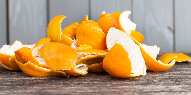 garbage rind tangerines peel from tangerines peeled on a wooden table, orange peel to throw in the trash peel plant part stock pictures, royalty-free photos & images