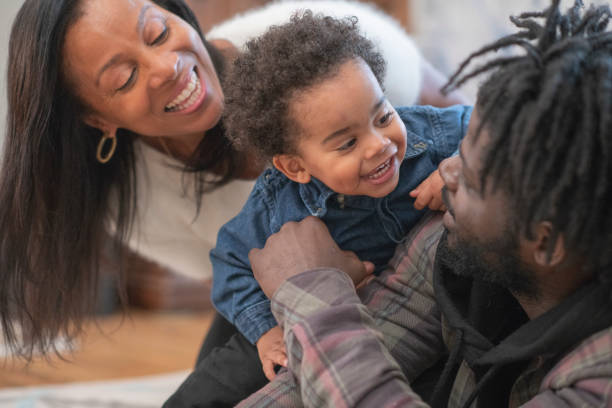 istock Laughing little boy playing with his family 1160262050