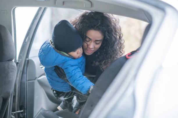 istock Mother putting her son in a carseat 1160262057