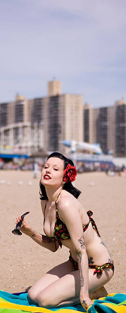 Young woman with in red green bikini on beach stock photo