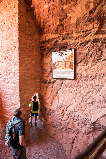 Colorado, USA - July 7, 2018: Father and son explore a Kiva at a replica cliff dwelling in Manitou Springs