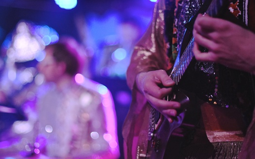 Midsection Of Guitarist Performing At Illuminated Music Concert