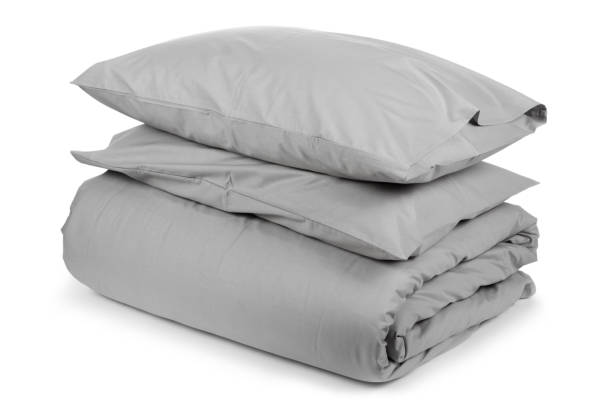 istock linen with pillows and blanket isolated 1160271084