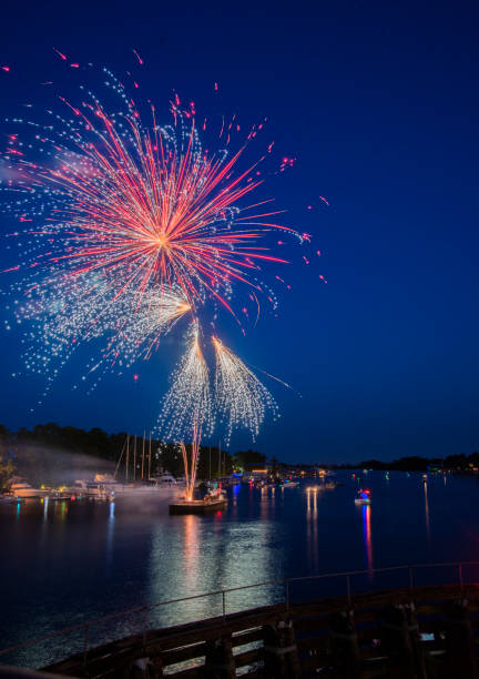 istock Colorful fireworks launched from a barge reflected in the river water 1160271405
