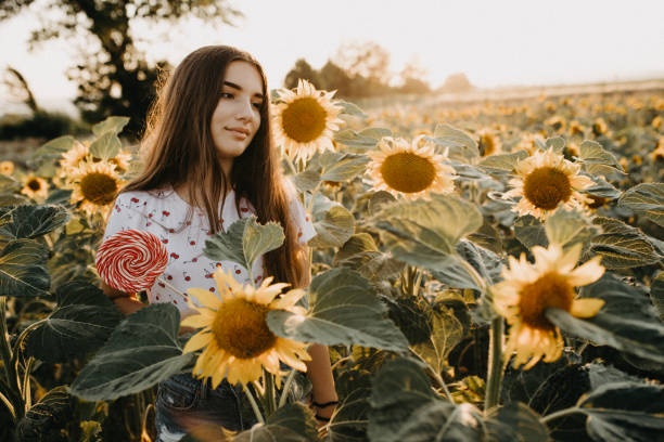 istock Young female in a sunflower field 1160271478
