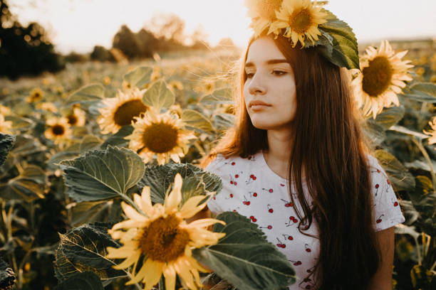 istock Young female in a sunflower field 1160272206