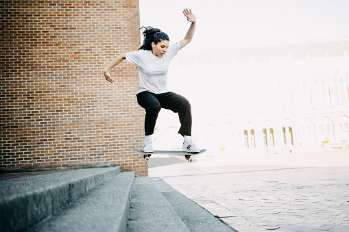 A talented Hispanic female skateboarder skates various urban features in the Seattle, Washington area.