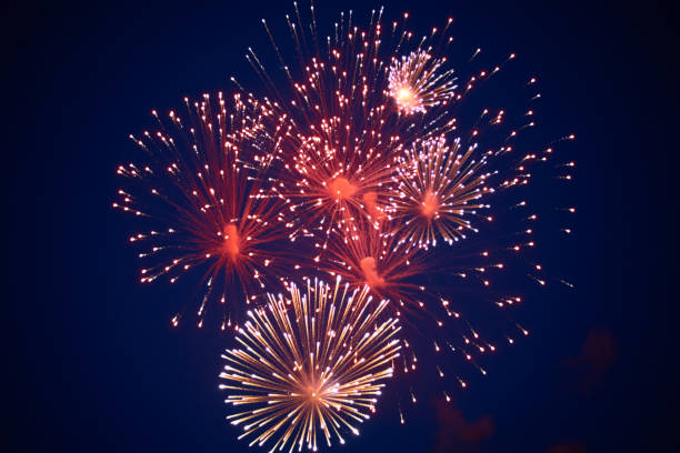 istock Inexpensive bright sparkling fireworks, red, with haze, in the night sky 1160275357