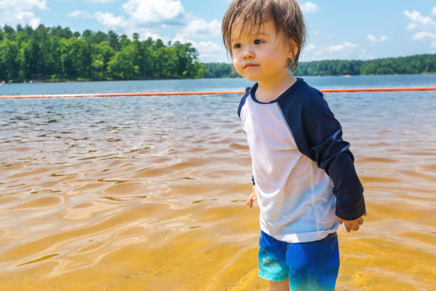 istock Toddler boy playing in a lake on a summer day 1160275616