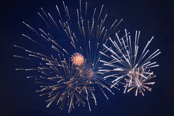 istock Cheap bright sparkling fireworks, yellow-white, with haze, in the night sky, background texture 1160275724