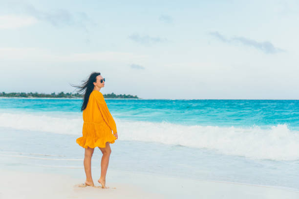 istock Young beautiful woman on tropical seashore in sunset. 1160277241