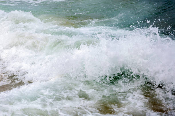 istock Waves crashes against the rocks on the beach, background with copy space 1160278767