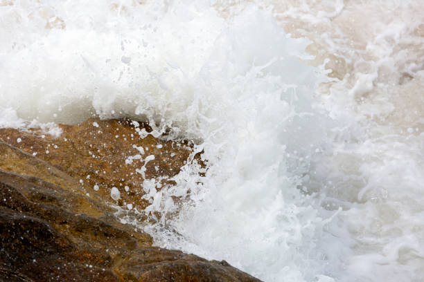 istock Waves crashes against the rocks on the beach, background with copy space 1160281310