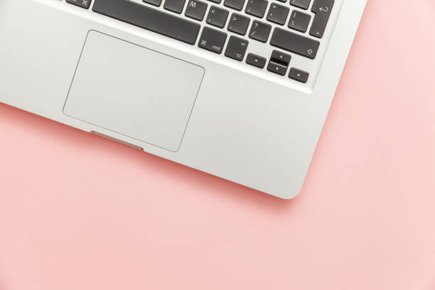 istock Keyboard laptop computer isolated on pink pastel desk background. Modern Information technology and sofware advances 1160281502
