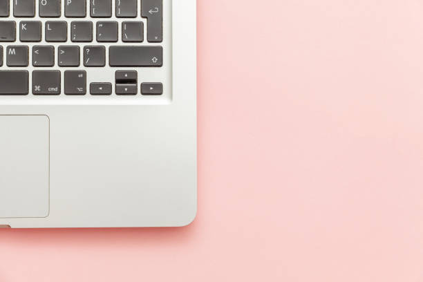 istock Keyboard laptop computer isolated on pink pastel desk background. Modern Information technology and sofware advances 1160281521